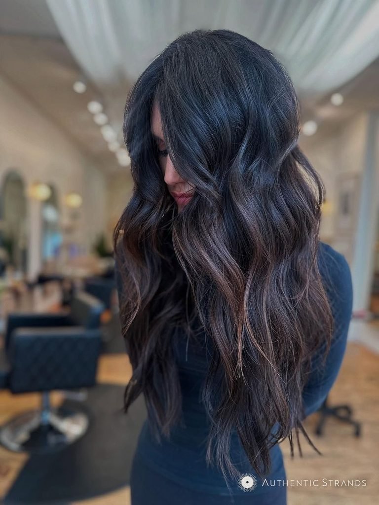 Long wavy espresso brown hair with soft warm tones and a glossy finish